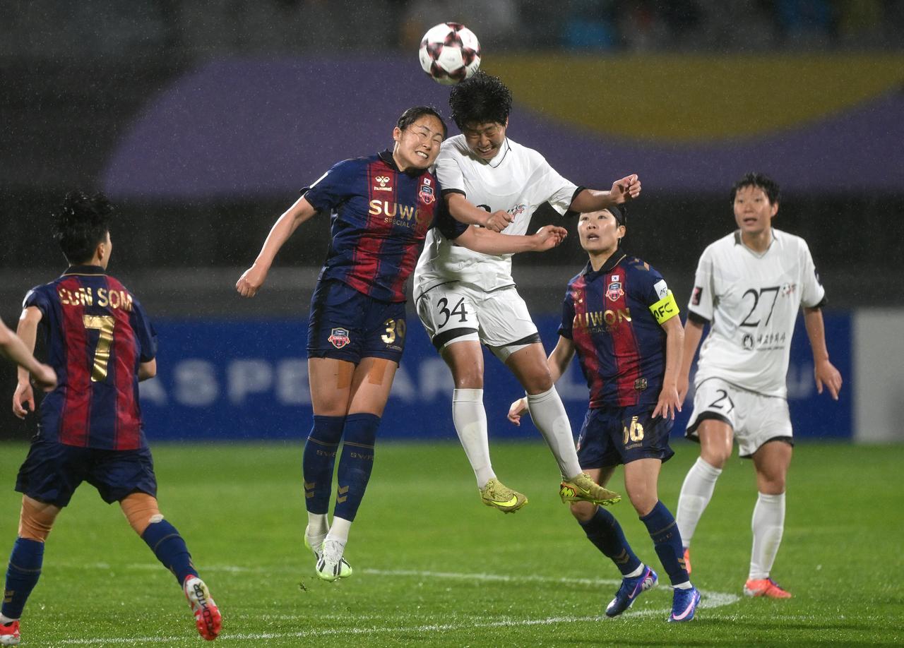 Pak Ye Gyong (C) of Naegohyang Women's FC fights for the ball with Haruhi Suzuki (2nd L) of Suwon FC Women during the AFC Women's Champions League semi-final football match on May 20, 2026. (AFP Photo)