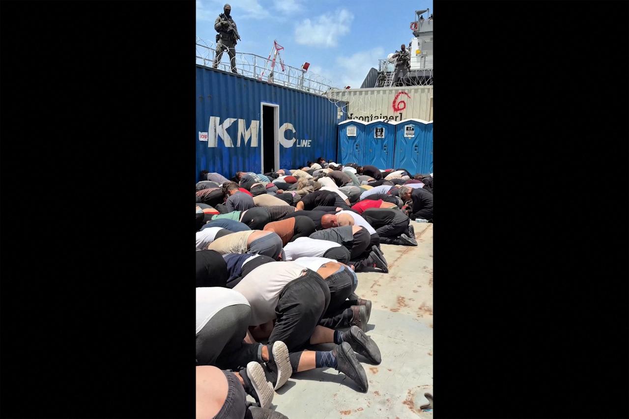 This screen grab taken from footage released on Israeli National Security Minister Itamar Ben Gvir’s X account on May 20, 2026 shows dozens of detained activists from the Gaza-bound aid flotilla kneeling with their hands tied behind their backs and their foreheads on the ground on the deck of a military boat in Israel. (AFP Photo)
