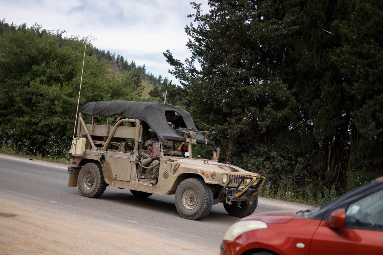 Israeli soldiers drive on a road near the Israel-Lebanon border after a Hezbollah drone attack that hit the northern border on May 19, 2026. (AFP Photo)