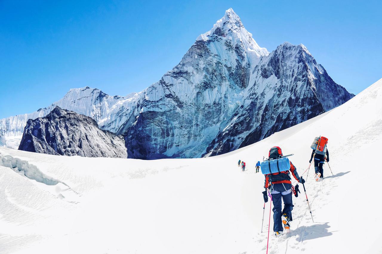 Group of climbers reaching the Everest summit in Nepal. (photo via Adobe Stock)
