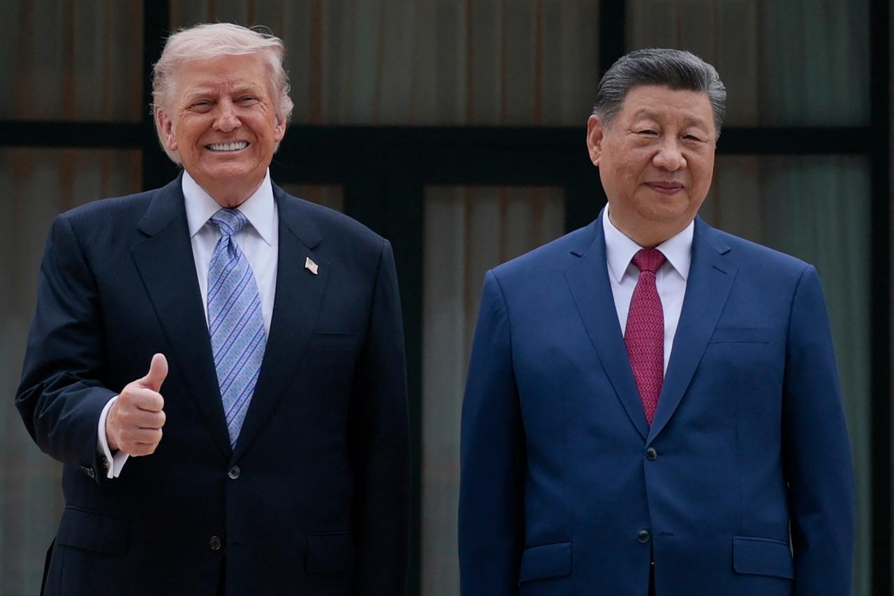 US President Donald Trump (L) poses for photos with China’s President Xi Jinping during a visit to Zhongnanhai Garden in Beijing on May 15, 2026. (AFP Photo)