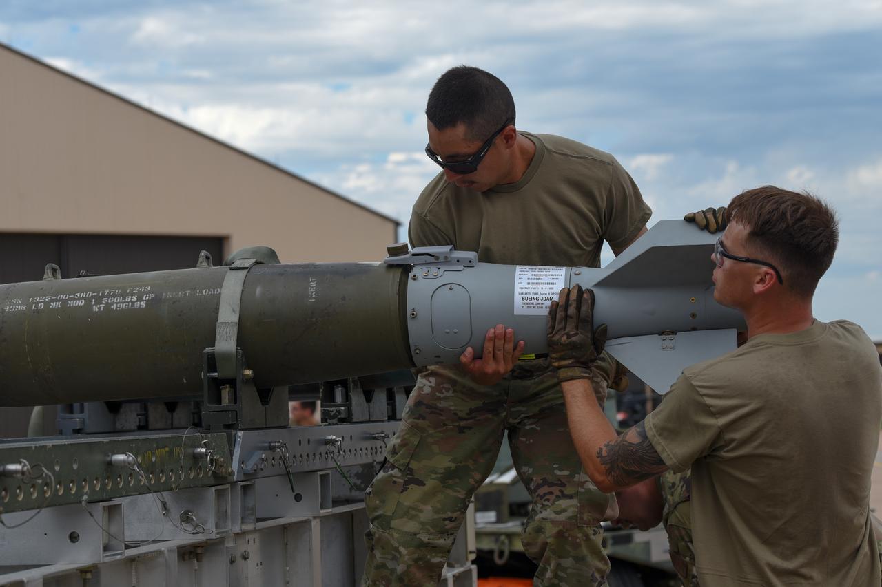Airman positions a tail assembly on an inert Joint Direct Attack Munition during the Lone Star Challenge at Dyess Air Force Base, Texas, July 13, 2023. (Photo via U.S. Air Force)
