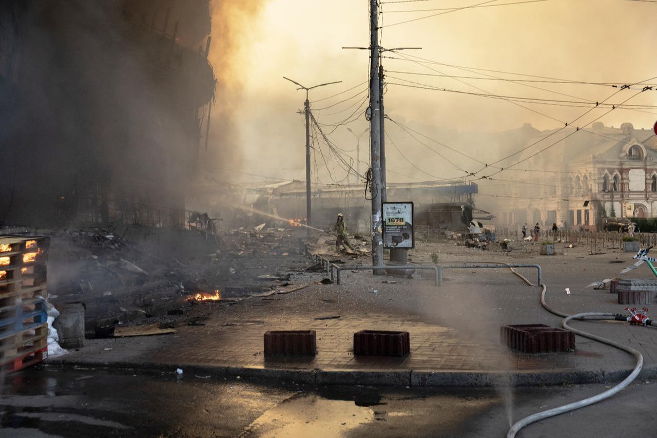 Ukrainian firefighters work at the site next to heavily damaged buildings following Russian strikes in Kyiv on May 24, 2026. (AFP Photo)