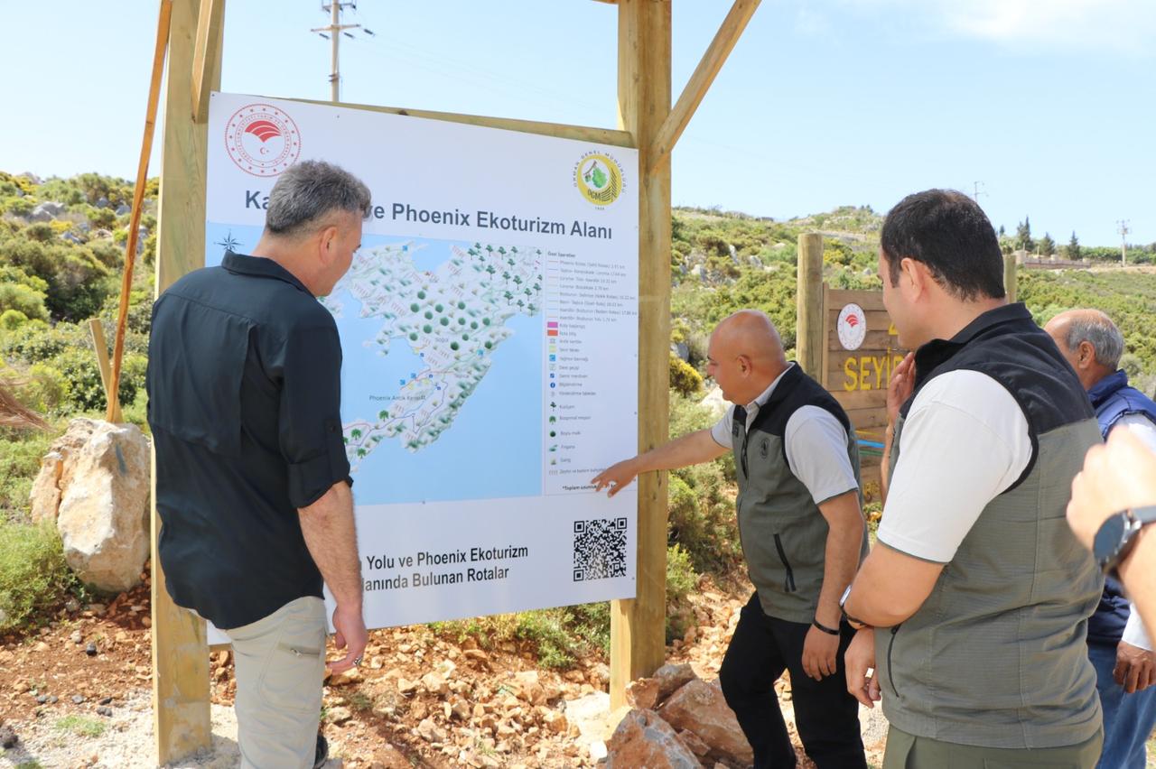 Officials inspect an information board for the Carian Way and Phoenix Ecotourism Area project in Marmaris, Mugla, Türkiye. (AA Photo)