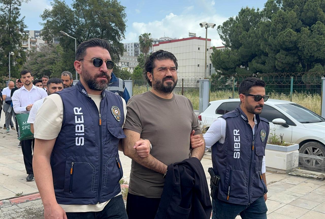 Television commentator Rasim Ozan Kutahyali (C) is escorted by police officers following his detention as part of an illegal betting investigation in Türkiye, May 17, 2026. (AA Photo)