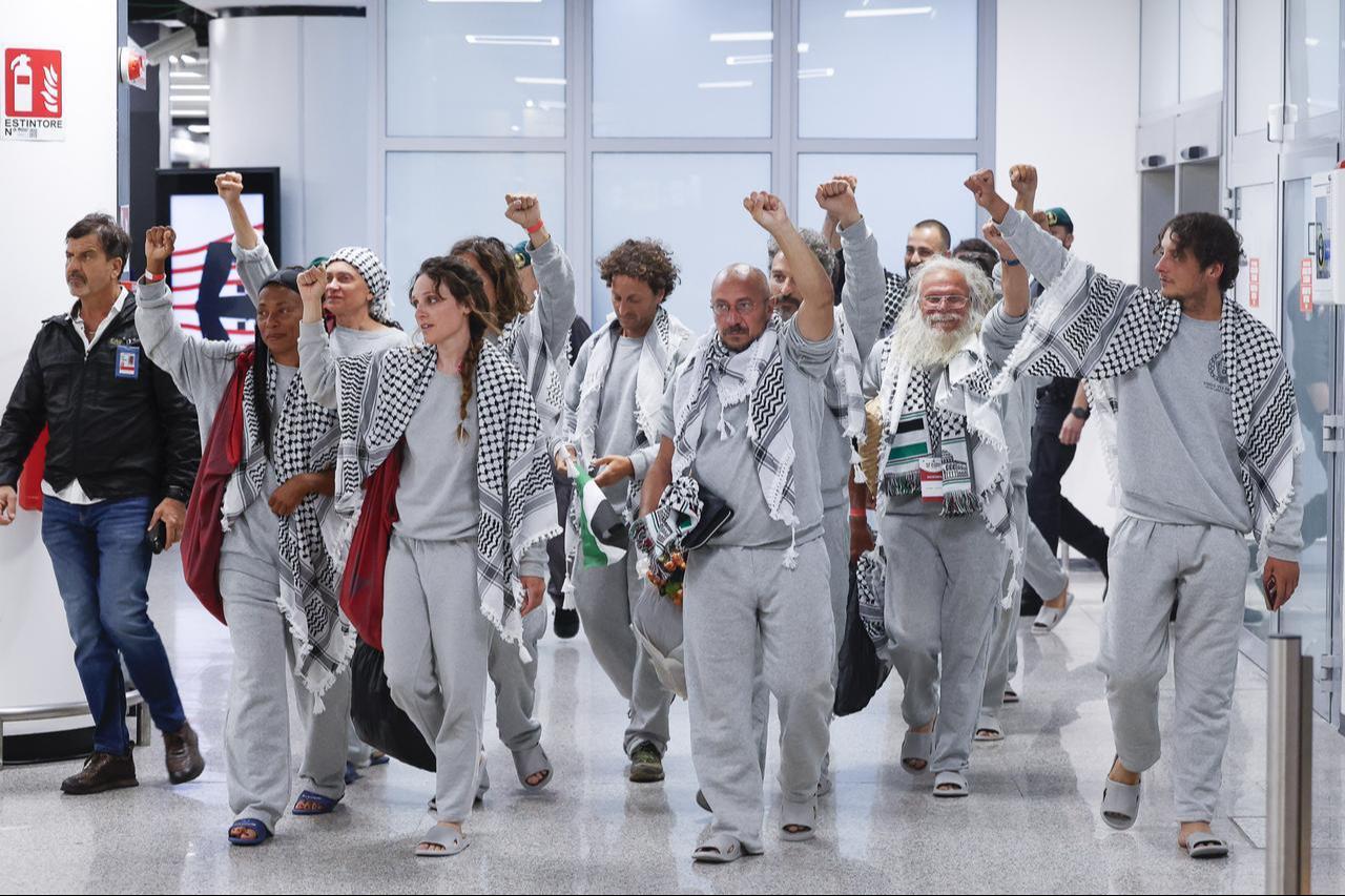 Activists of the Global Sumud Flotilla wearing Israeli prison uniforms arrive from Istanbul, Türkiye, at Rome's Fiumicino international airport, Italy, May 21, 2026. (AA Photo)