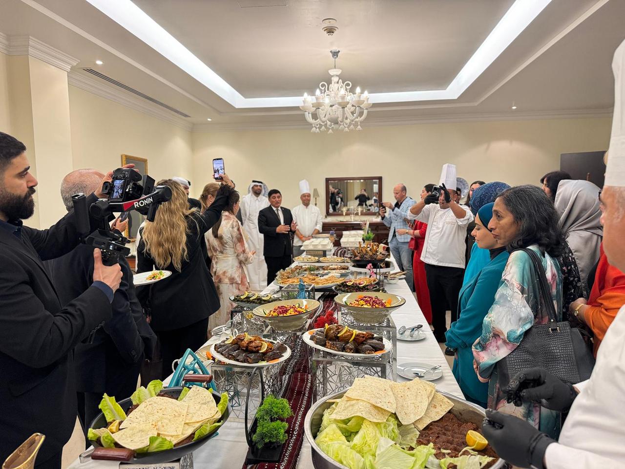 Guests gather around a Turkish cuisine presentation during Turkish Cuisine Week in Doha, Qatar, May 22, 2026. (AA Photo)