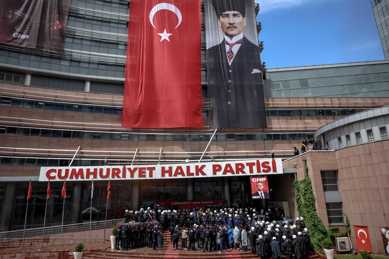 A banner of founder of the Turkish Republic Mustafa Kemal Ataturk and Turkish national flag hang on the buliding's facade as Turkish riot police attempt to enter the Republican People's Party (CHP) headquarters in Ankara, Türkiye on May 24, 2026. (AFP Photo)