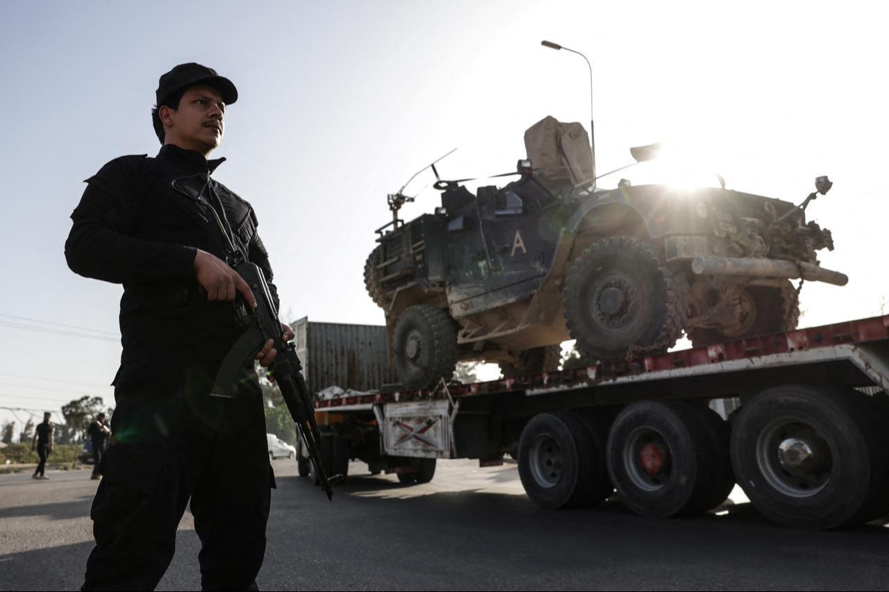 Syrian security stands guard as a convoy of US military equipment is transported along the Damascus–Amman highway toward the southwestern city of Daraa, as it travels near the capital Damascus, Syria, April 16, 2026. (AFP Photo)