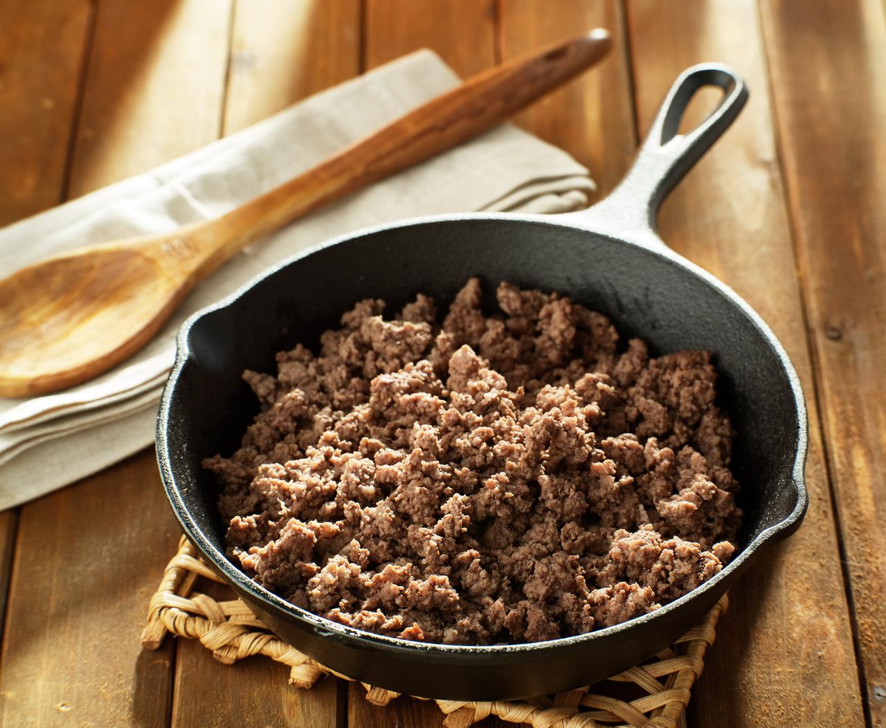 Browned ground beef in cast iron skillet (Adobe Stock Photo)
