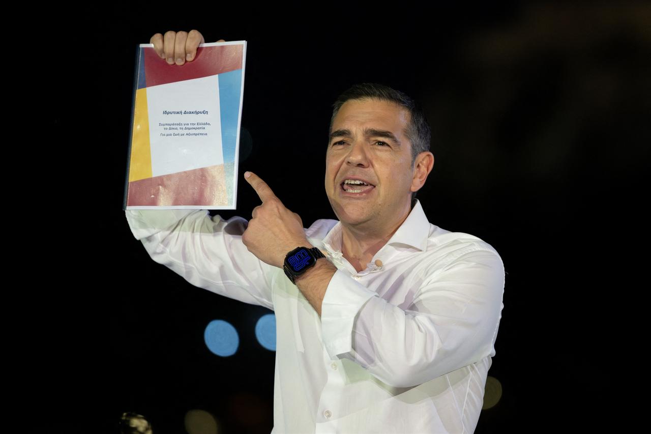 Greece’s former Prime Minister Alexis Tsipras points at founding declaration of his new political party ELAS (Hellenic Left Alignment) during a launching presentation of the party, in Athens, Greece, May 26, 2026, ahead of next year's elections. (AFP Photo)