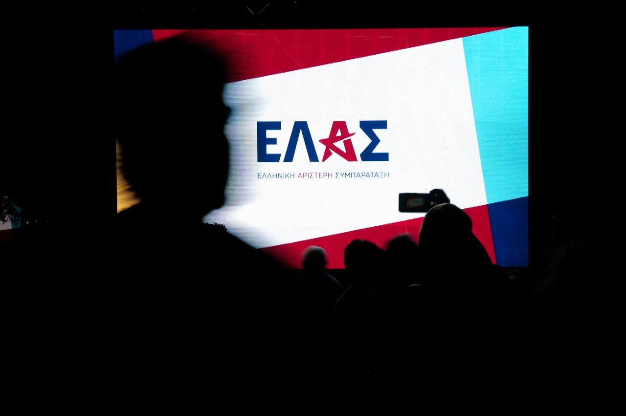 Party supporters take photos and walk by a big screen displaying the name of the new party after the presentation of Greece's former Prime Minister Alexis Tsipras new political party ELAS, in Athens, Greece, May 26, 2026, ahead of next year's elections. (AFP Photo)