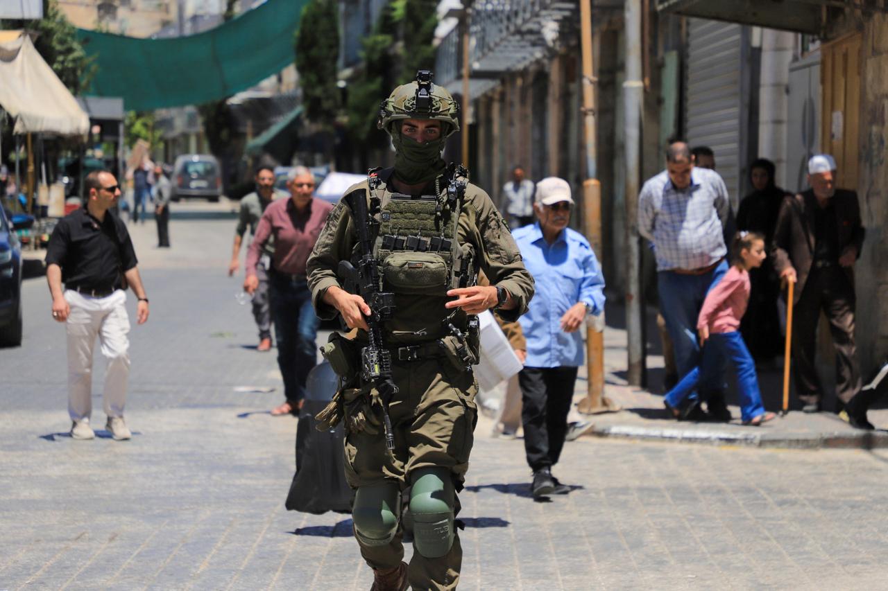 Israeli settlers, under the protection of Israeli forces, raid the Old City area of Hebron in the southern West Bank, Palestine, on May 23, 2026. (AA Photo)