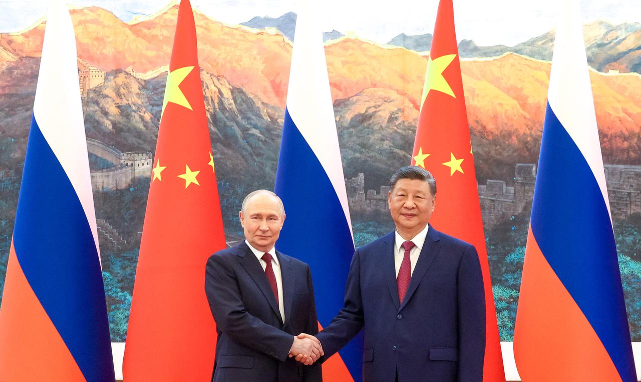 Russia's President Vladimir Putin (L) shakes hands with China's President Xi Jinping during a meeting in Beijing on May 20, 2026. (AFP Photo)