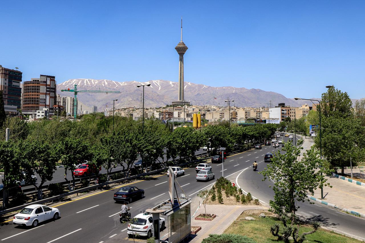 Motorists drive their vehicles along a road near Milad (Birth) Tower, the tallest tower in the country at 435 meters and part of Tehran's International Trade and Convention Center, in Tehran, May 26, 2026. (AFP Photo)