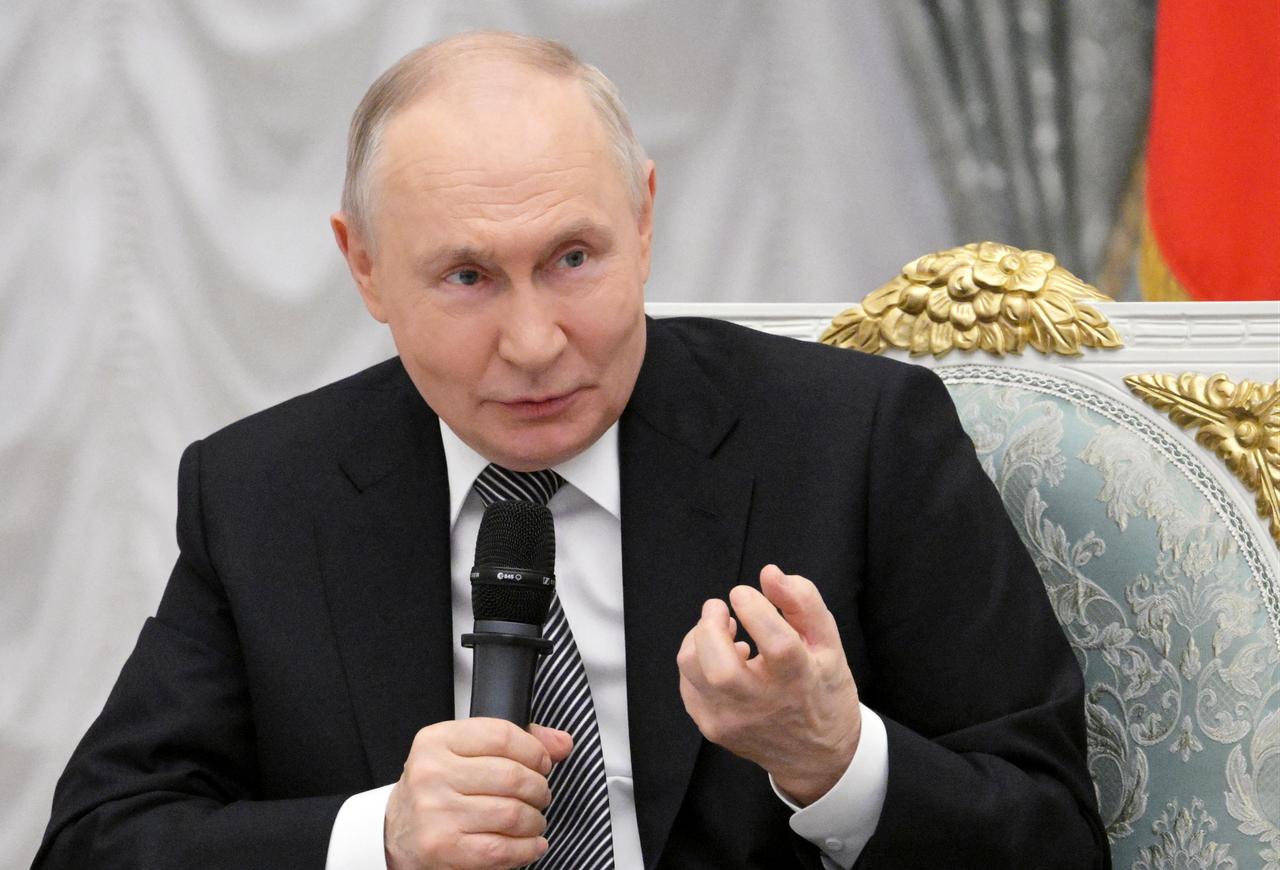In this pool photograph distributed by the Russian state agency Sputnik, Russia's President Vladimir Putin meets with graduates of the "Time of Heroes" programme at the Kremlin in Moscow, Russia, May 22, 2026. (AFP Photo)