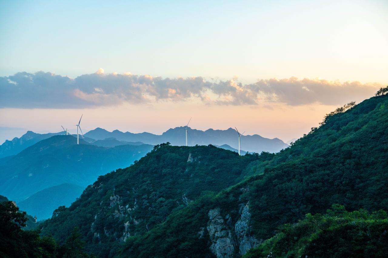 Wind turbines stand along mountain ridges in China. (Adobe Stock Photo)