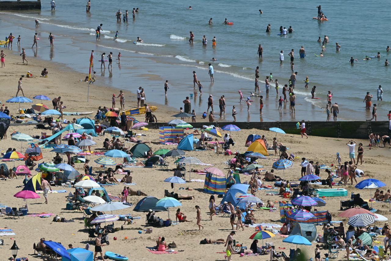 Sunbathers relax in the sunshine on Bournemouth beach on the south coast of England on May 26, 2026. (AFP Photo)