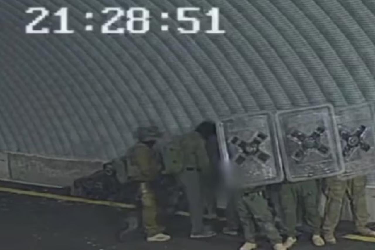 This leaked video broadcast by Channel 12 news on August 6, 2024, purports to show troops abusing a Palestinian detainee at the Sde Teiman detention facility in southern Israel on July 5, 2024. (Photo via Channel 12)