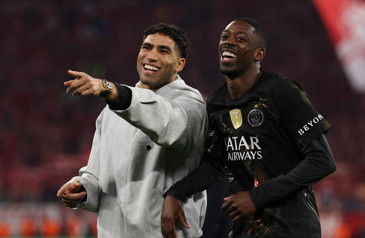 Morocco's defender #02 Achraf Hakimi and Paris Saint-Germain's French forward #10 Ousmane Dembele celebrate after the UEFA Champions League second-leg, semi-final football match between FC Bayern Munich and Paris Saint-Germain (PSG) in Munich, southern Germany, May 6, 2026. (AFP Photo)