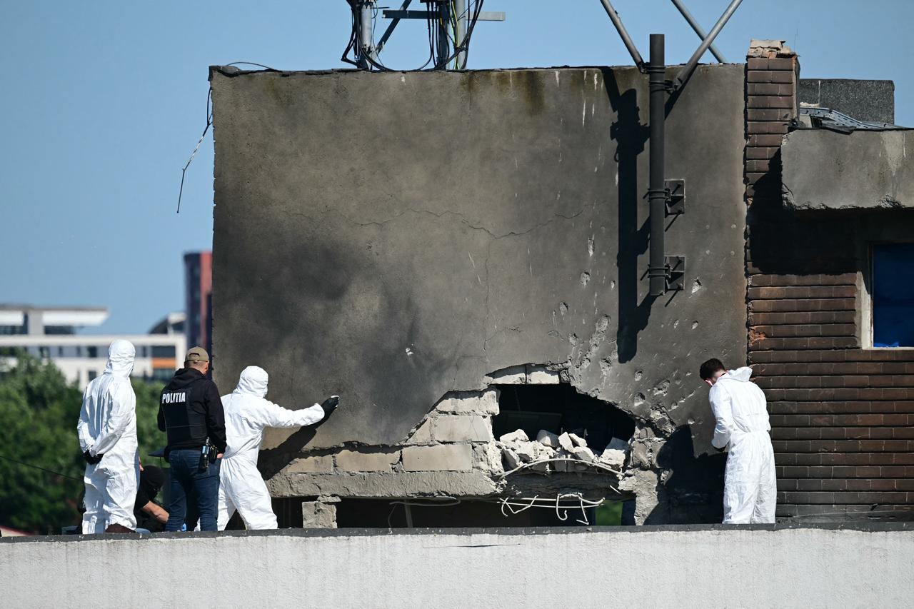 Police and forensic investigators examine the location of impact after a drone struck an apartment building in Galati, eastern Romania, May 29, 2026. (AFP Photo)