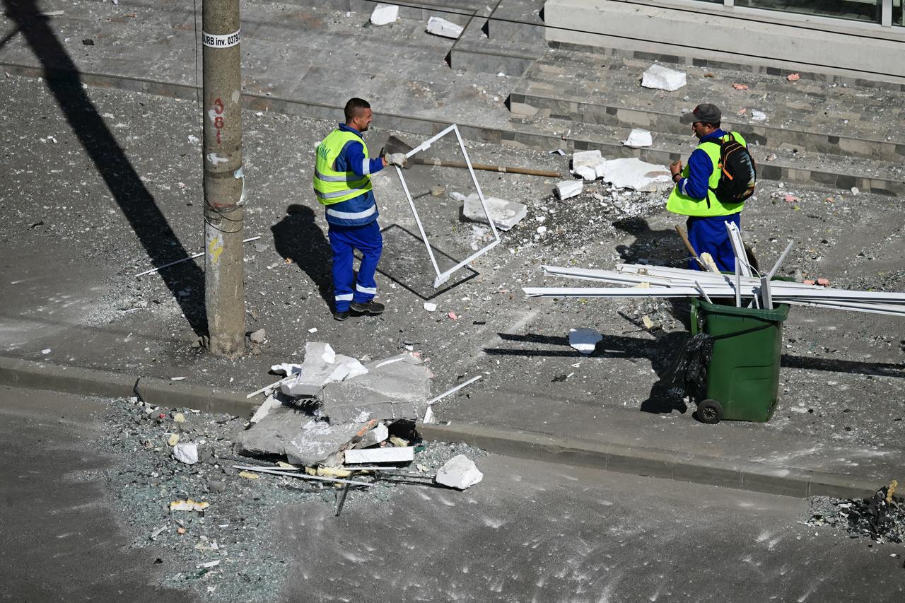Municipal workers clear debris from the street after a drone struck an apartment building in Galati, eastern Romania, May 29, 2026. (AFP Photo)