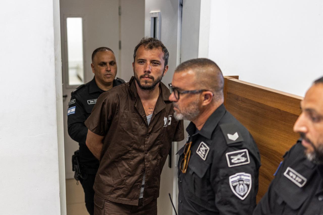 Security personnel escort Brazilian activist Thiago Avila to a court in Ashkelon on May 3, 2026. (AFP Photo)