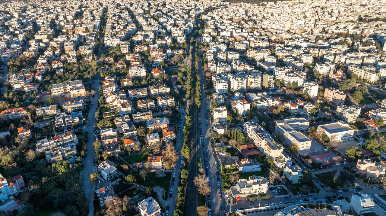 Aerial view of apartment blocks and an overground metro line running through Marousi, a suburb of Athens, Greece. (Adobe Stock Photo)