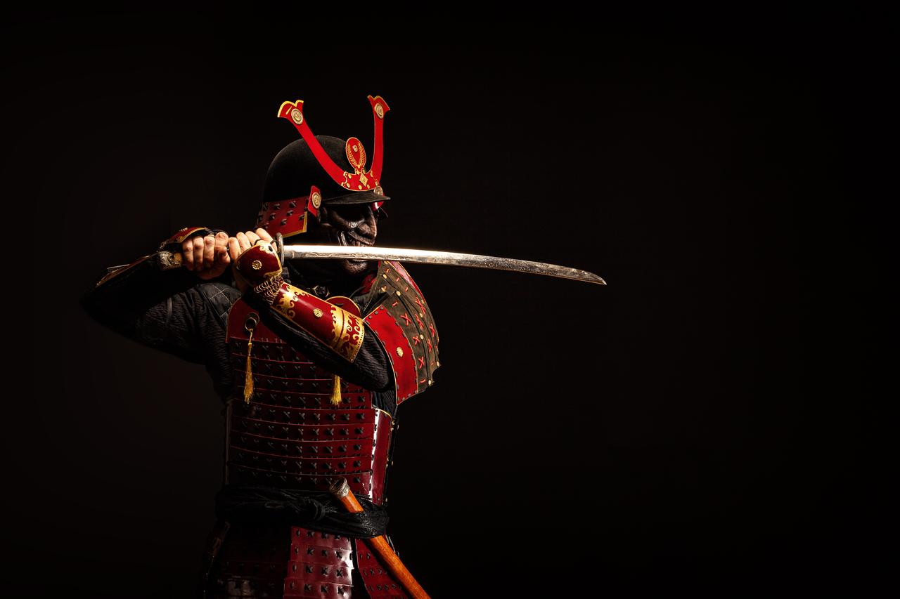 A Japanese samurai in armor holds a sword, undated. (Adobe Stock Photo)