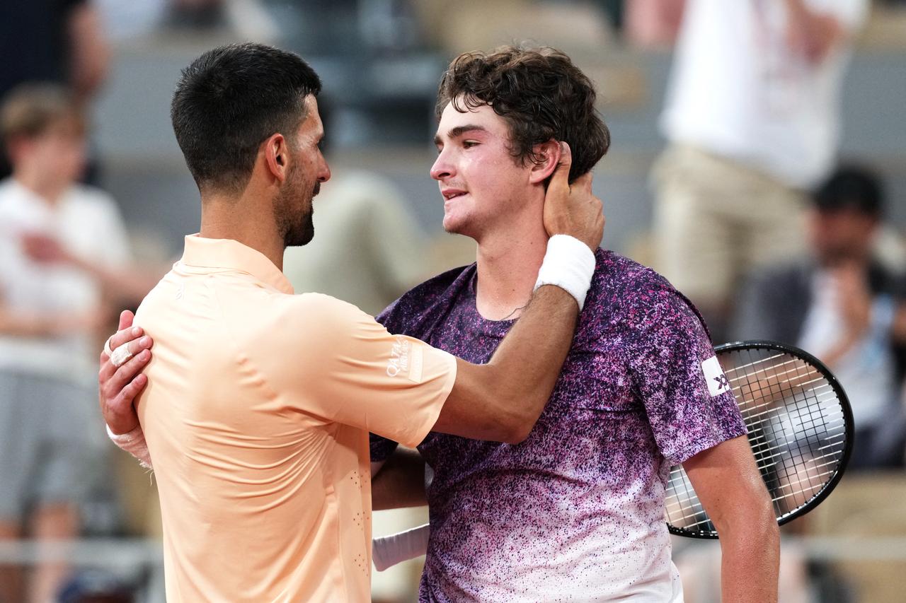 Winner Brazil's Joao Fonseca (R) greets Serbia's Novak Djokovic at the end of their men's singles match on day 6 of the French Open tennis tournament on Court Philippe-Chatrier at the Roland-Garros Complex in Paris, May 29, 2026. (AFP Photo)