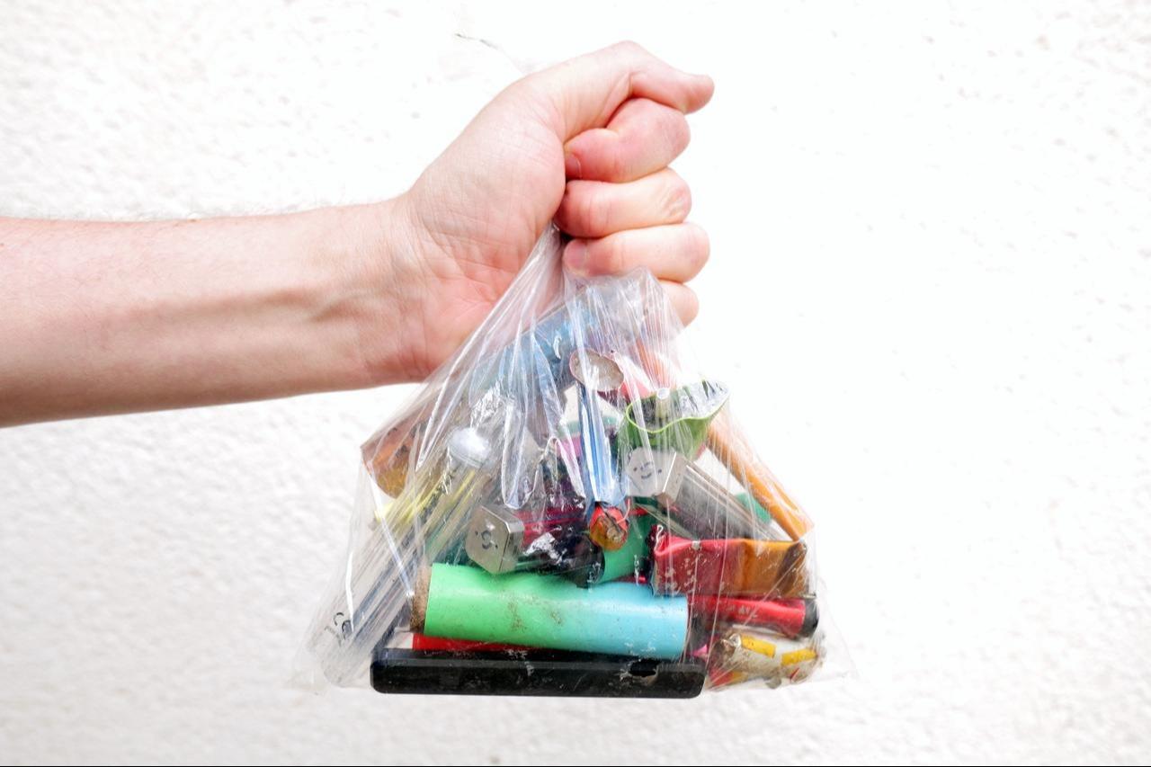 Discarded electronic cigarette components and batteries are seen in a plastic bag. (Adobe Stock Photo)