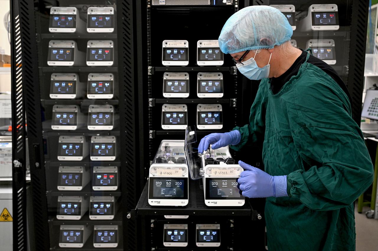 Scientist Justin Bourke inspects a CL1 unit containing containing cells,  May 5, 2026. (AFP Photo)