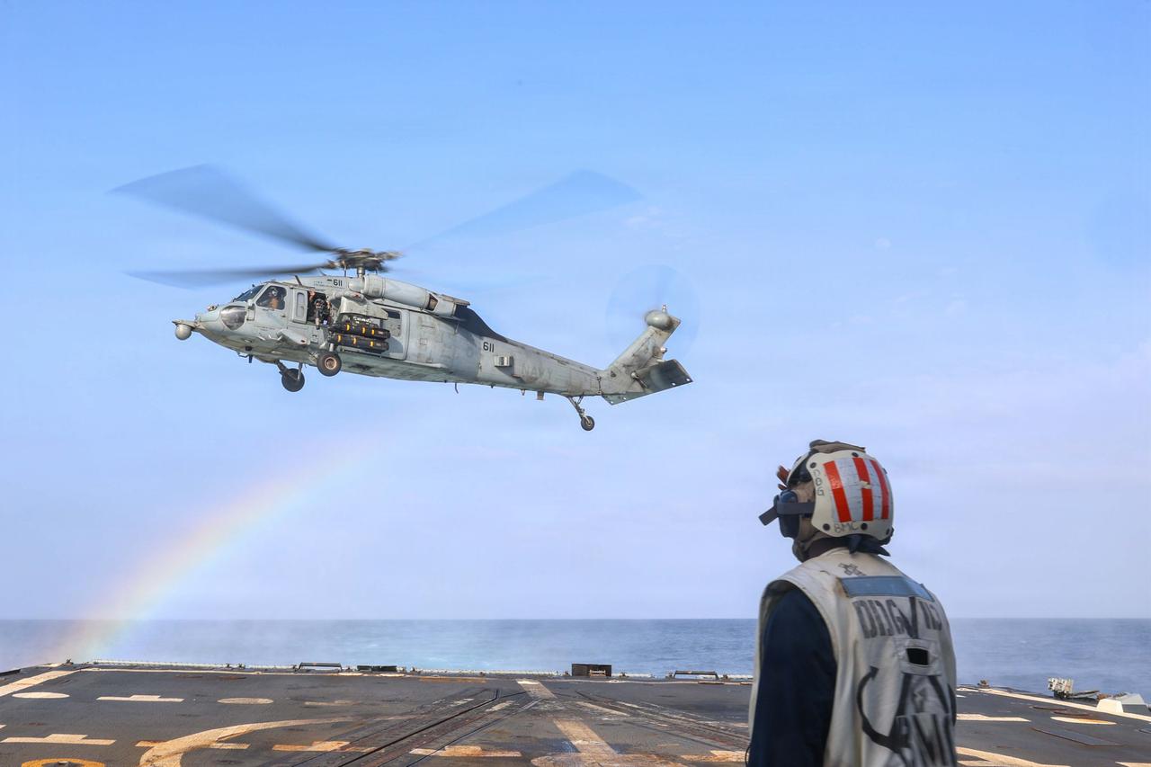 A U.S. Sailor, aboard the Arleigh Burke-class guided-missile destroyer USS John Finn (DDG 113), conducts flight quarters with an MH-60S Sea Hawk helicopter during Operation Epic Fury, March 29, 2026. (Photo via U.S. Navy)