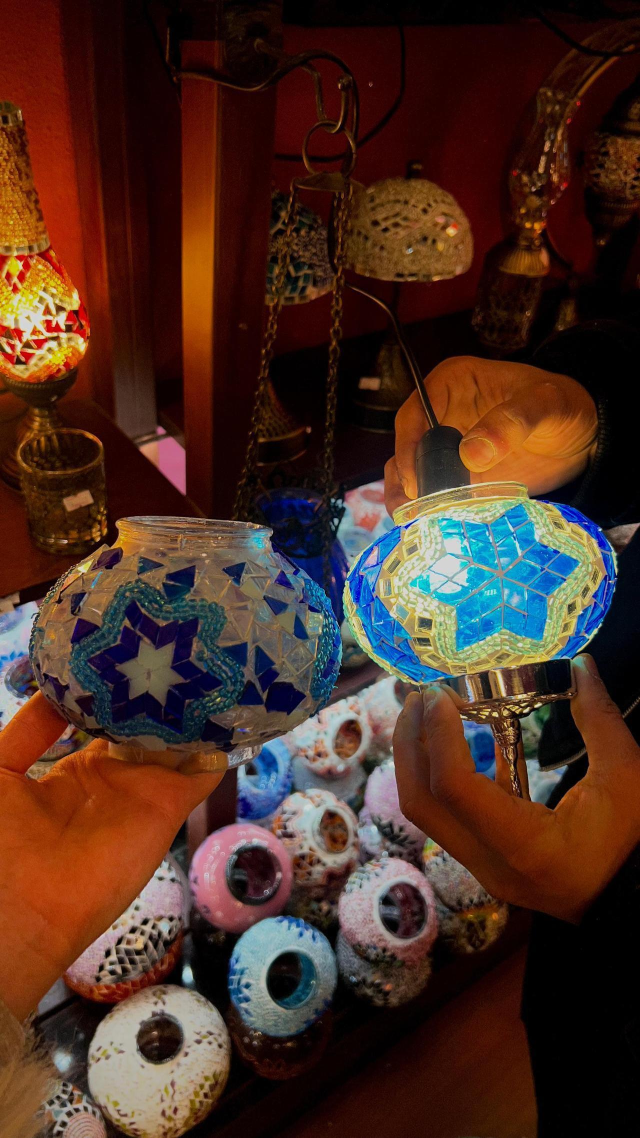 The photo highlights the differences between the original mosaic lamp design and a newer version crafted with updated materials. (Photo by Türkiye Today)