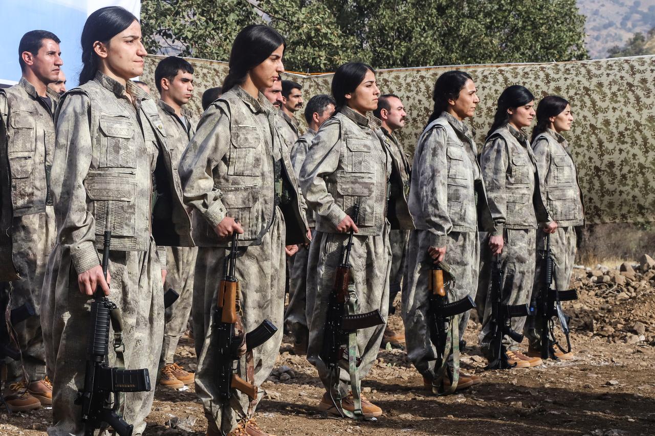 Terrorist organization PKK members stand during a ceremony in northern Iraq on October 26, 2025. (AFP Photo)