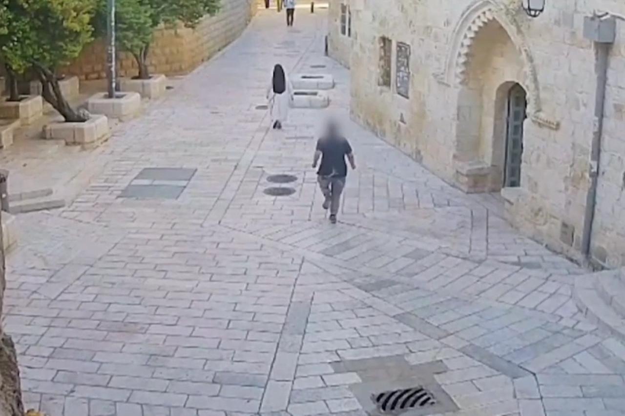 The screengrab from a video shows an Israeli Jewish extremist shoving a French nun from behind near King David's Tomb in Jerusalem's Old City on April 28, 2026. (Photo via X/@IL_police)