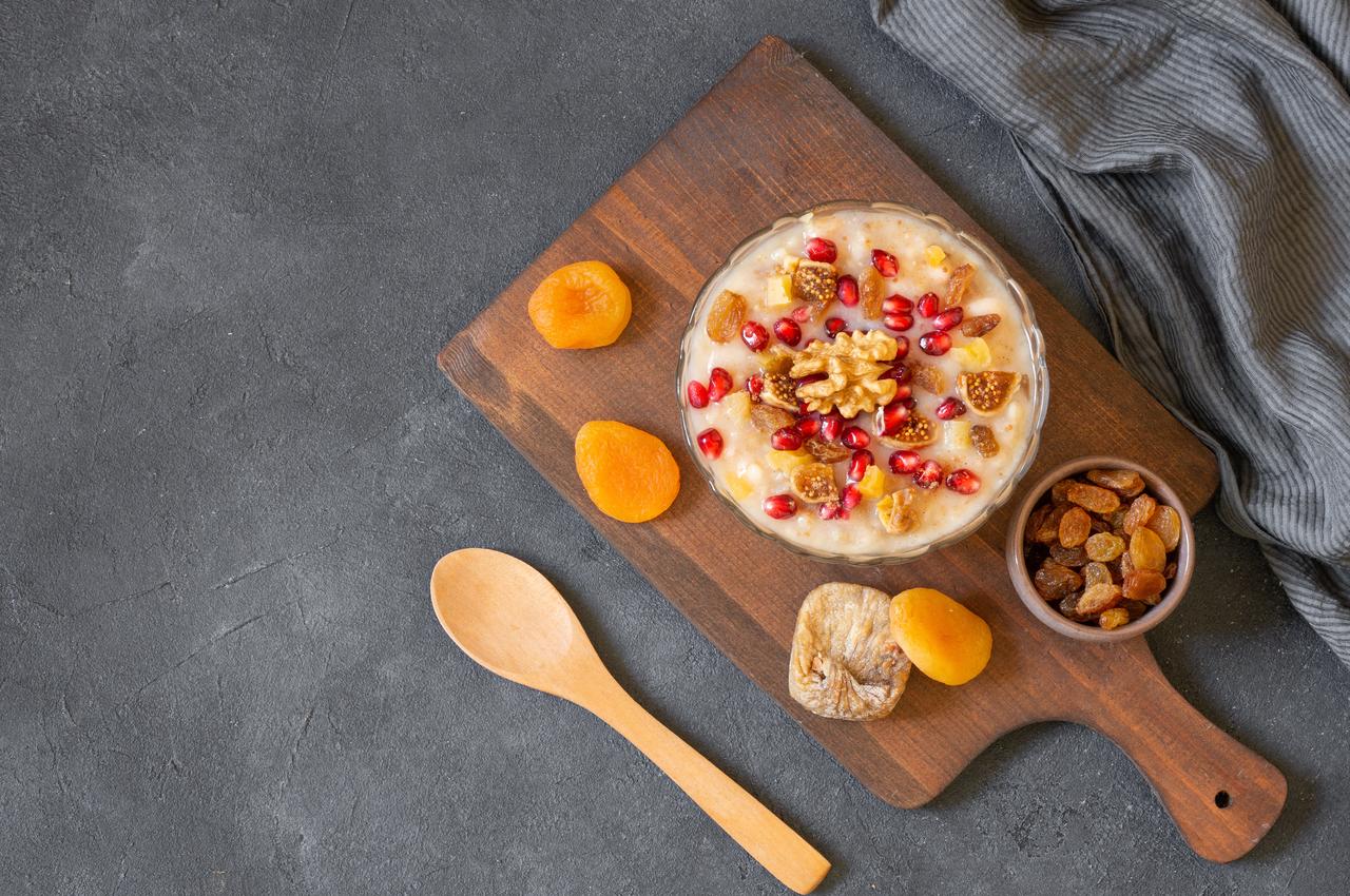 A bowl of asure served with dried apricots, figs, raisins, and pomegranate seeds, accessed on May 8, 2026. (Adobe Stock Photo)