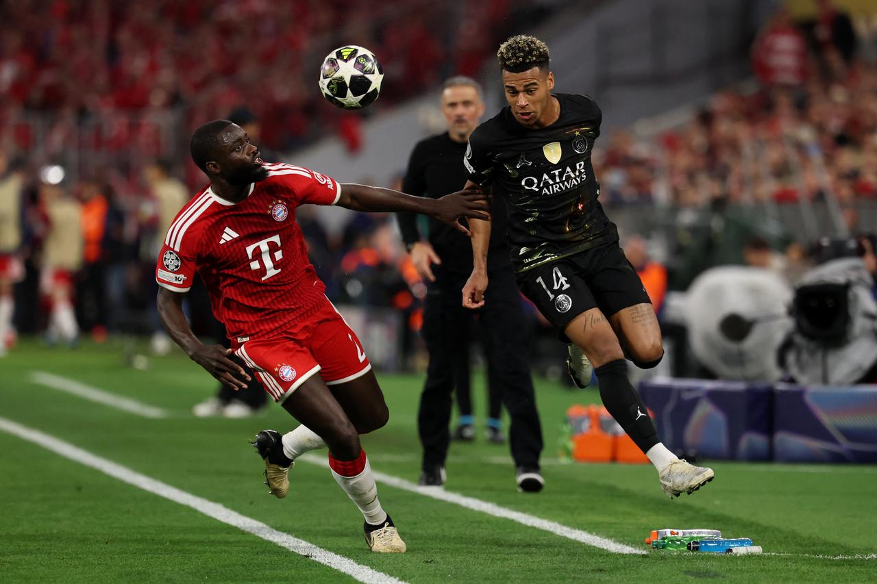 Bayern Munich's French defender #02 Dayot Upamecano (L) and Paris Saint-Germain's French midfielder #14 Desire Doue vie for the ball during the UEFA Champions League second-leg in Munich, Germany, May 6, 2026. (AFP Photo)