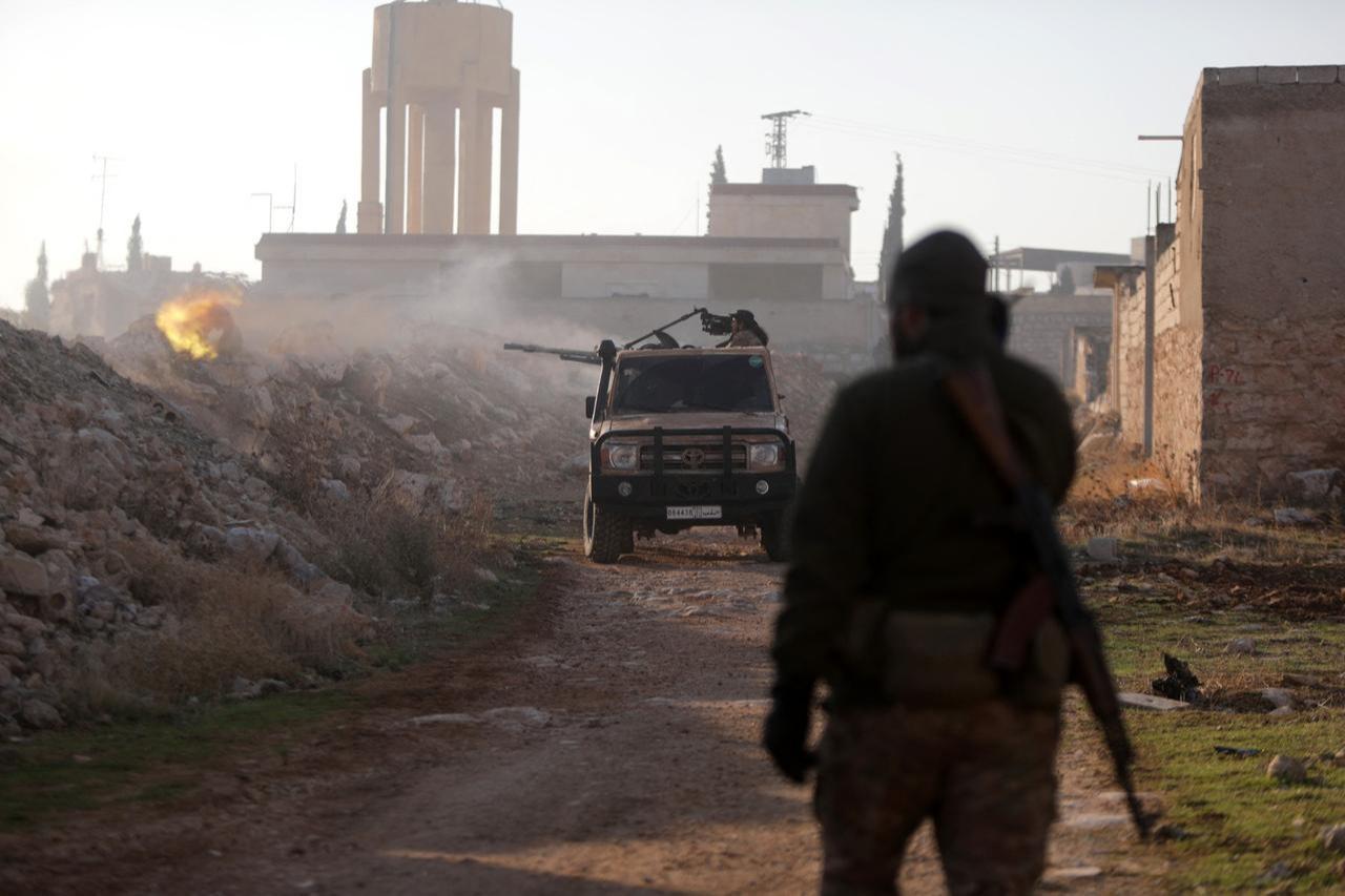 Fighters fire towards Syrian Army troops in the Rashidin district on the outskirts of Aleppo on Nov. 29, 2024. (AFP Photo)