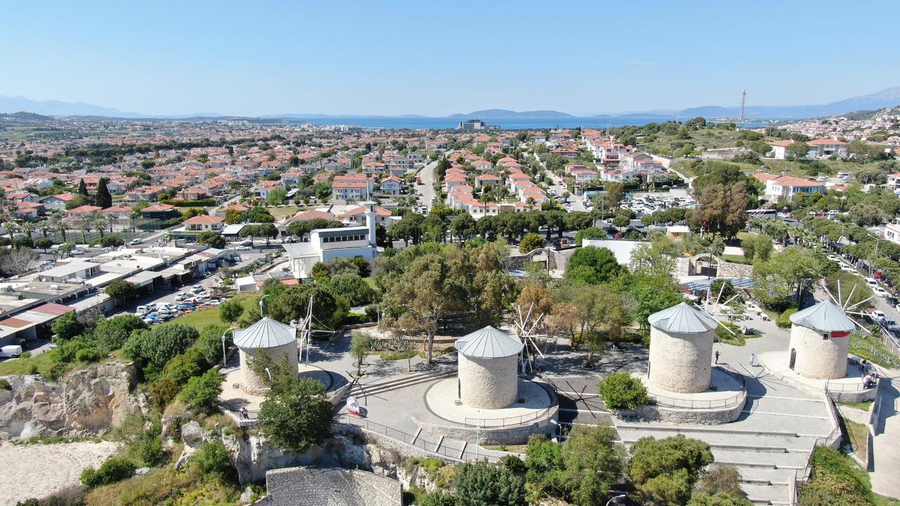 Windmills of Alacati, one of the town’s most iconic landmarks overlooking stone houses. Izmir, Türkiye, May 8, 2026. (IHA Photo)