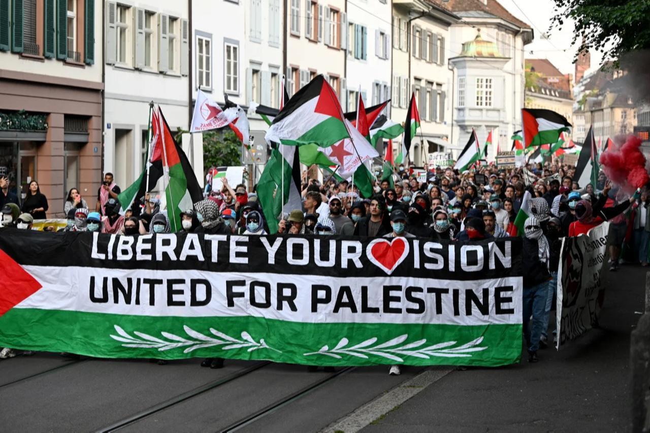 Protestors hold a banner and Palestinian flags during a demonstration against Israel's candidate before the grand final of the Eurovision Song Contest 2025 in Basel, Switzerland, May 17, 2025. (AFP Photo)