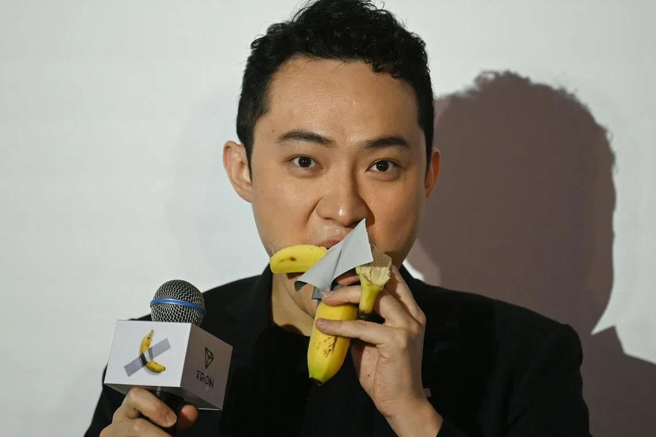 Crypto entrepreneur Justin Sun eating a banana, part of a conceptual work by Italian artist Maurizio Cattelan, which was sold at a Sotheby’s auction in New York. (AFP Photo)