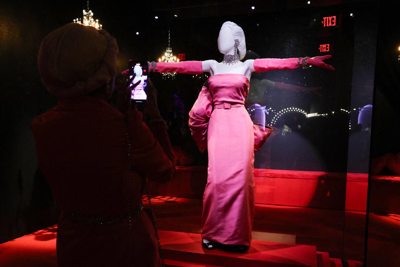 Guests photograph iconic Marilyn Monroe’s dresses, May 27, 2026. (AFP Photo)