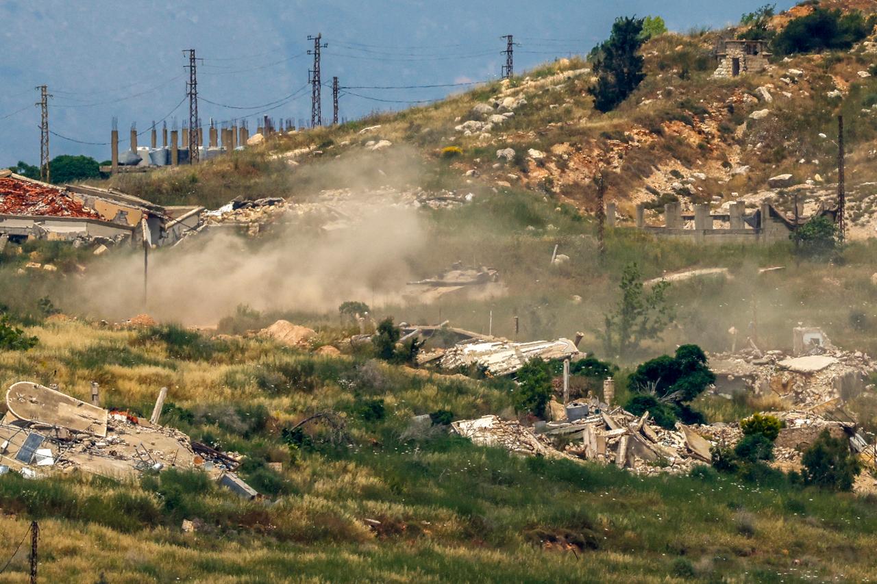 This picture taken from a position in the Upper Galilee region in northern Israel shows an Israeli tank taking position amid destroyed buildings in southern Lebanon on May 31, 2026. (AFP Photo)