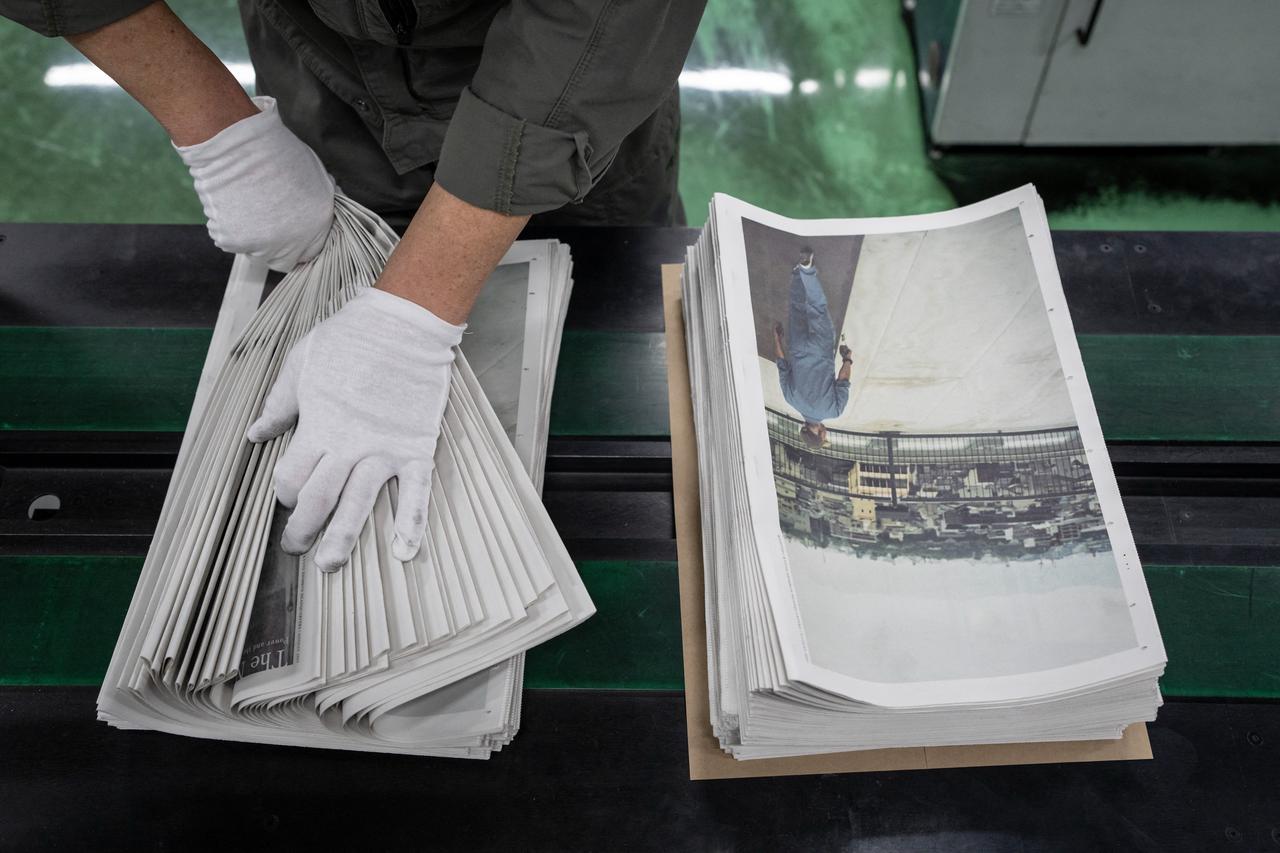 Staff member packing “The Newspaper” at the Kyoto Shimbun factory in Kumiyama, Kyoto prefecture. (AFP Photo)