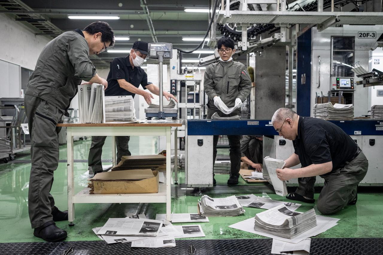 Staff members inspecting the printing quality at the Kyoto Shimbun factory in Kumiyama, Kyoto prefecture. (AFP Photo)