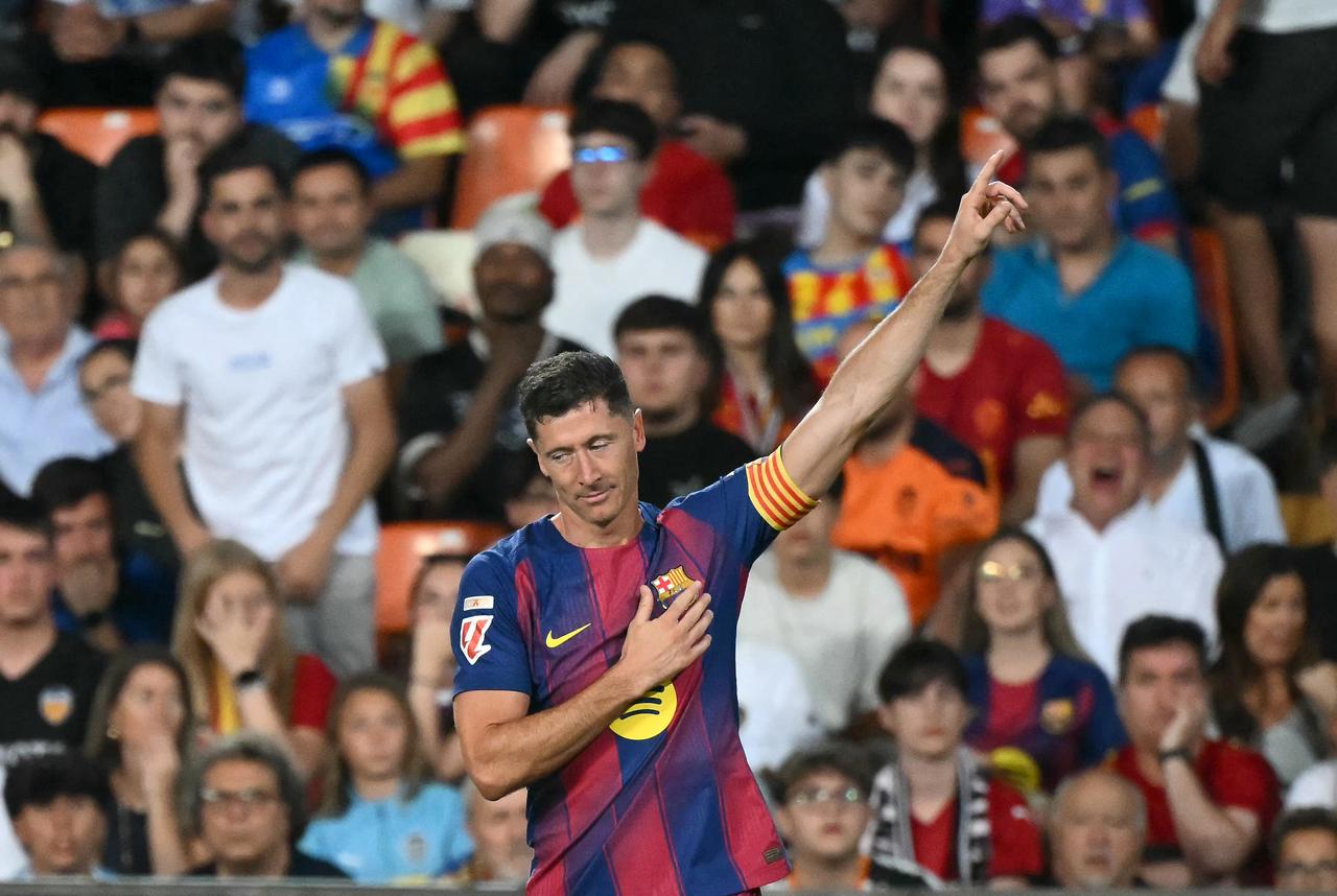 Barcelona's Polish forward #09 Robert Lewandowski celebrates scoring his team's first goal during the Spanish league football match between Valencia CF and FC Barcelona at Mestalla Stadium in Valencia, May 23, 2026. (AFP Photo)