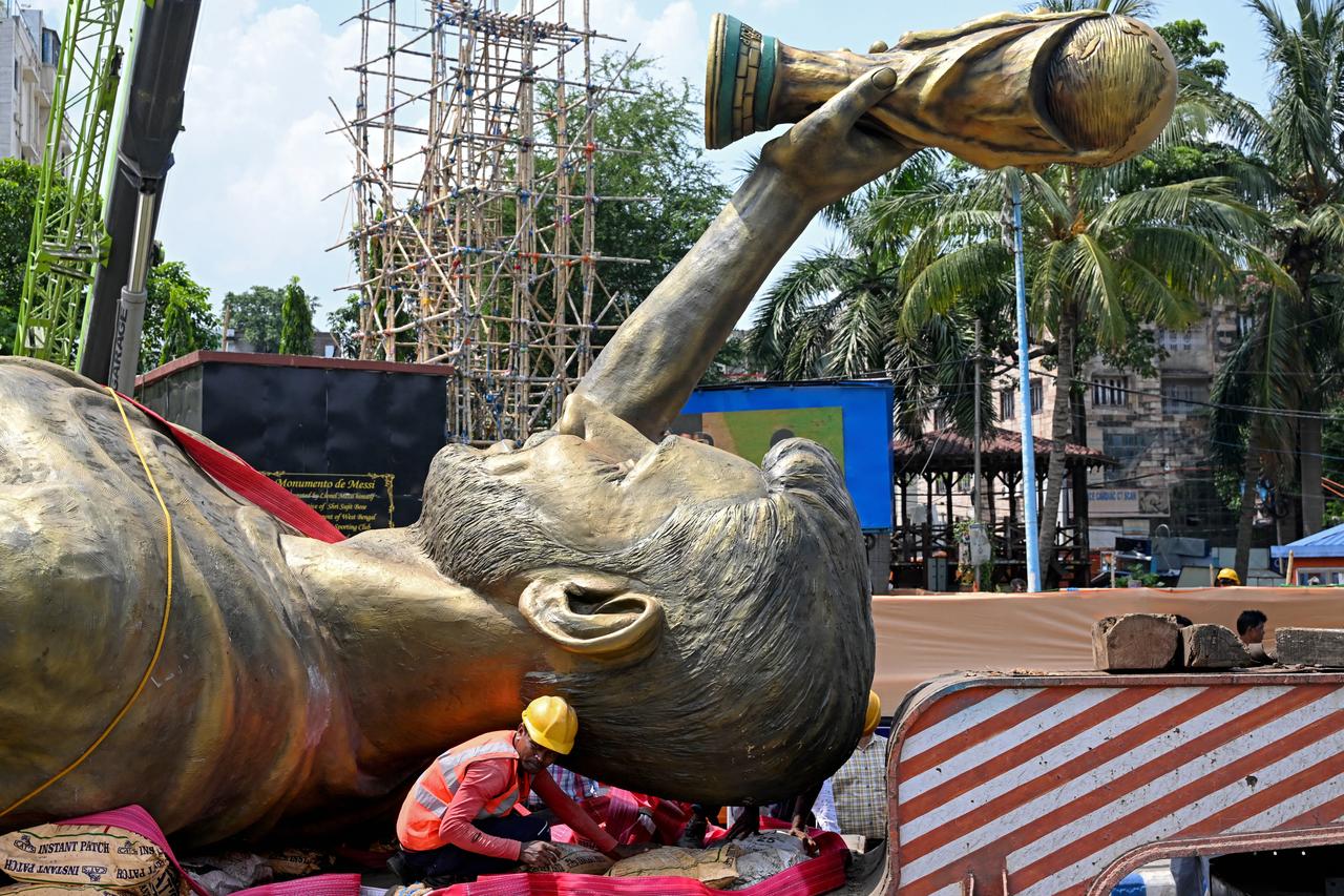 Worker sits next to a statue of Argentine football player Lionel Messi after its removal, June 1, 2026. (AFP Photo)