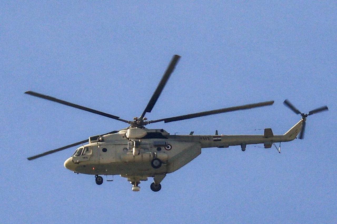 An Egyptian Air Force Mil Mi-8 "Hip" military transport helicopter flies over near the border with Egypt in Rafah in the southern Gaza Strip, December 16, 2023. (AFP Photo)