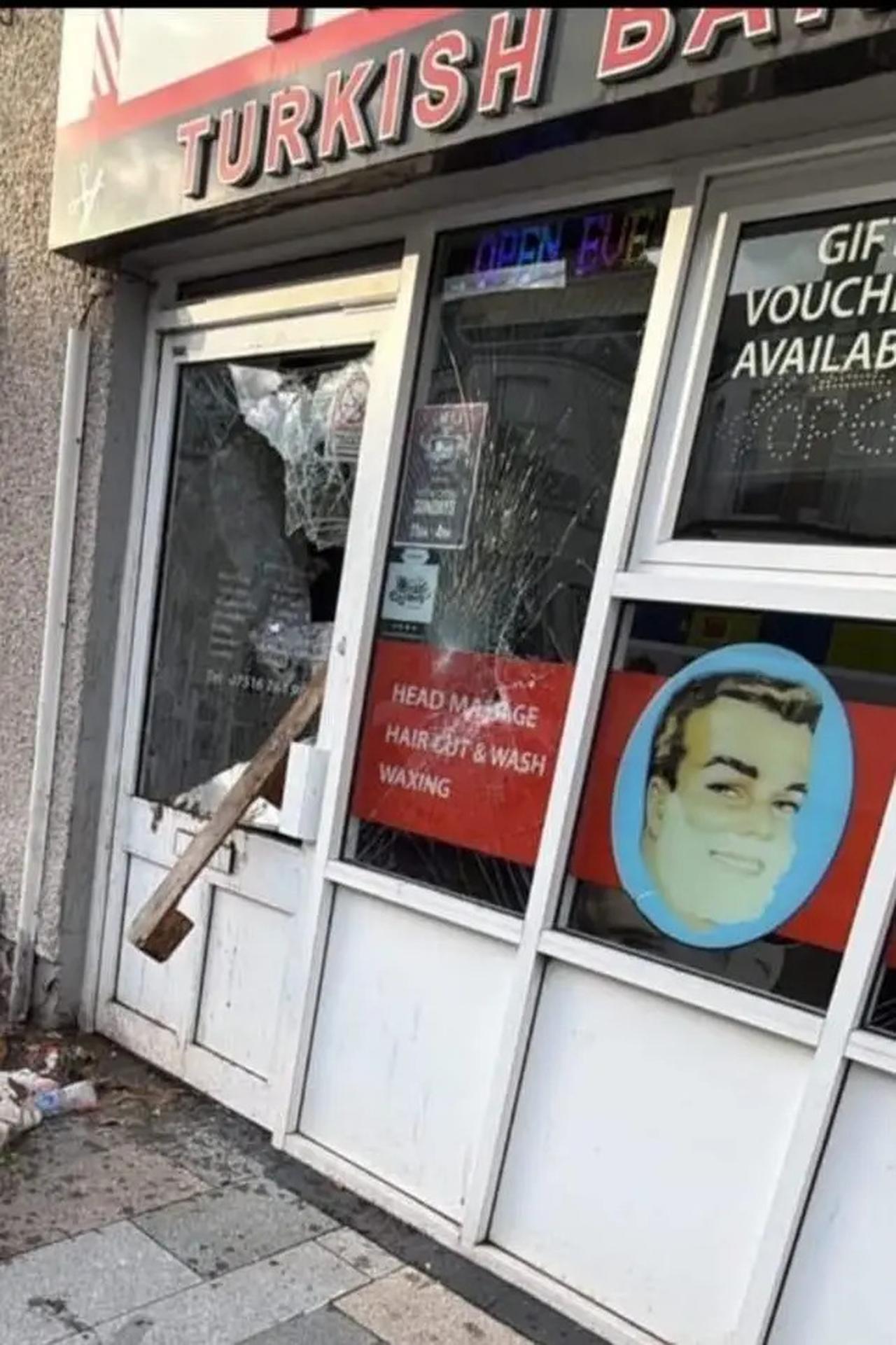 A Turkish barber whose windows were smashed during protests in Ballyclare, north of Belfast, accessed on June 10, 2026. (Photo via BBC)